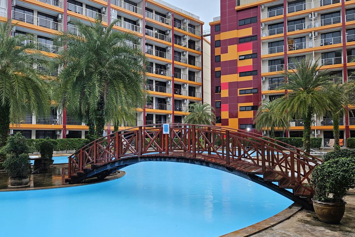 Pool with a wooden bridge at 777 Beach Condo