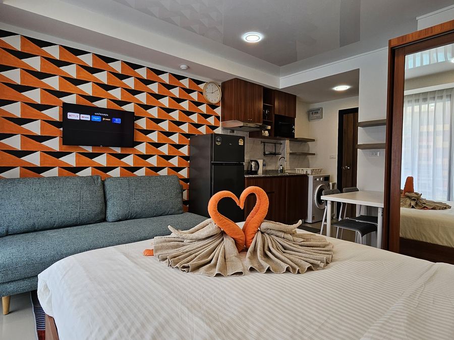 777 Beach Condo: studio with an orange accent wall